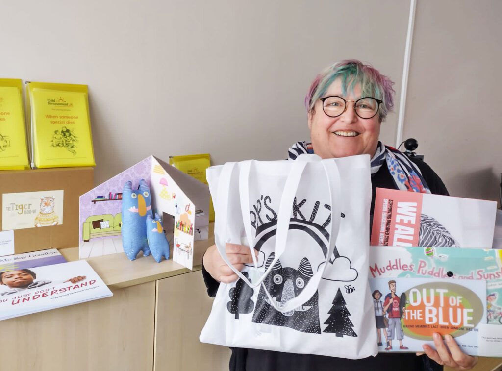 Lady holding children's bereavement books