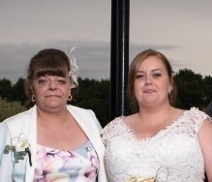 Bride and mum at wedding looking at camera