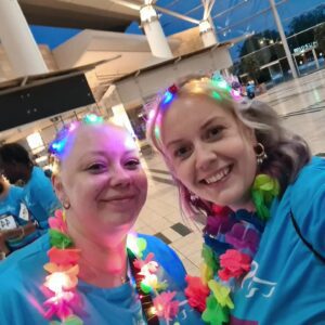 Two women looking at camera dressed up for a fun run