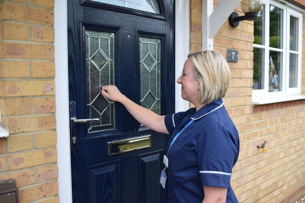 Nurse knocking at front door