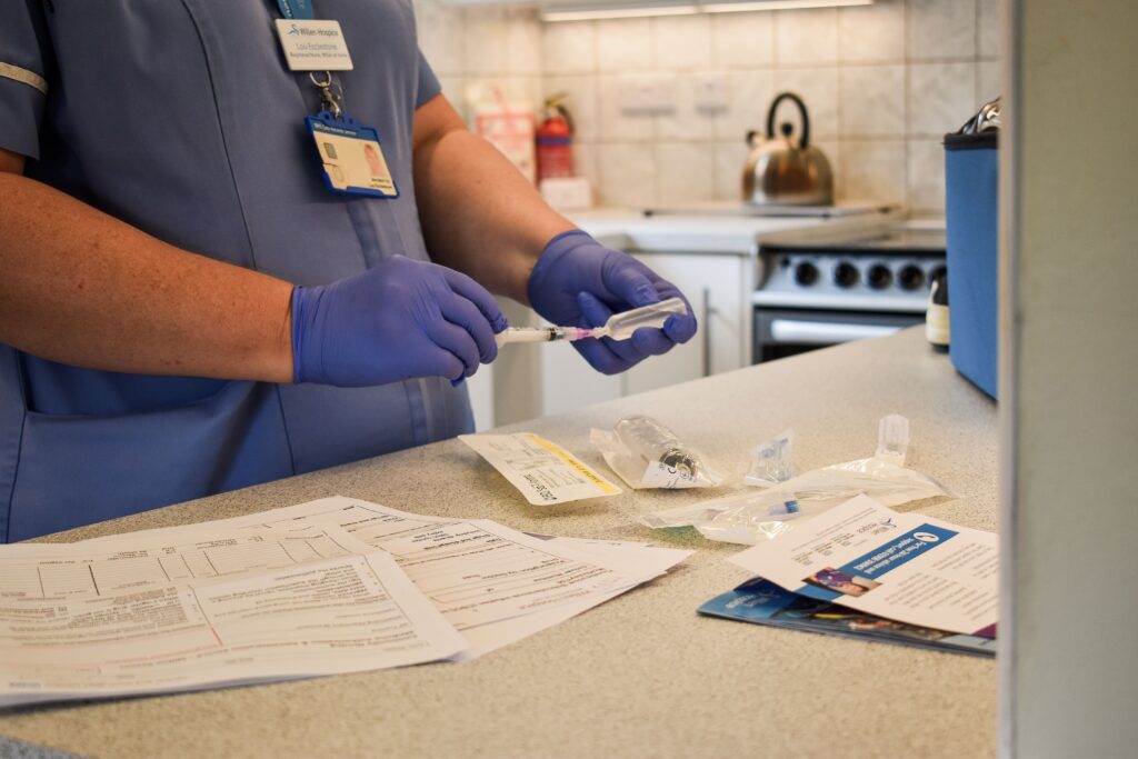 Nurse preparing syringe in a patient's home