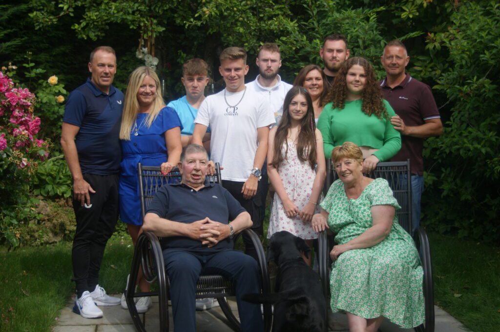 Large family posing in the garden together