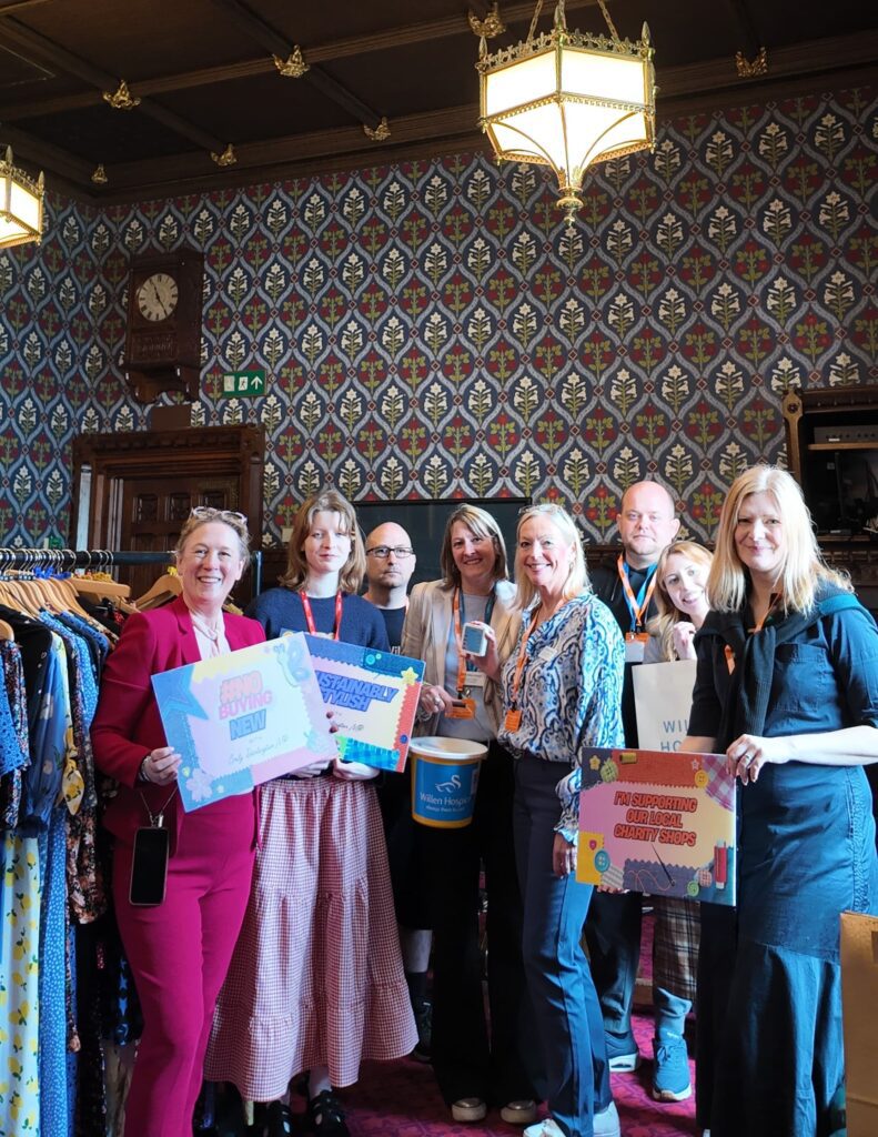 Group of people in a historical room with shopping rails