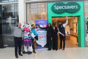 Group of people cheering outside a Specsavers store