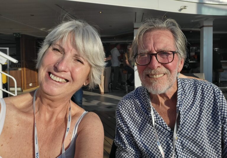 Couple smiling for camera at an outdoor event